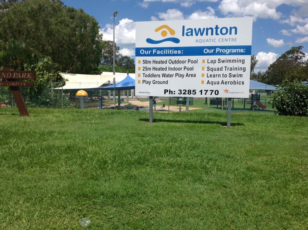 A sign for Lawnton swimming pool which you can visit on the Caboolture train line