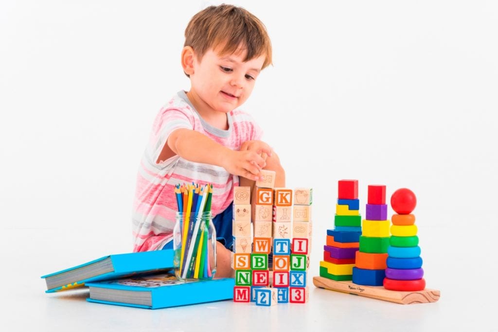 A child playing with bricks at a toy library brisbane