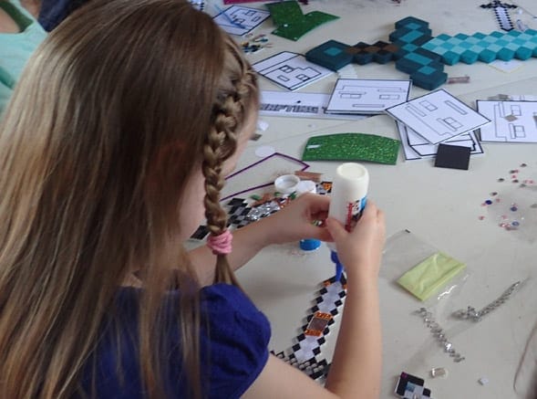 Girl crafting a sword at the Minecraft Party Crafting Table