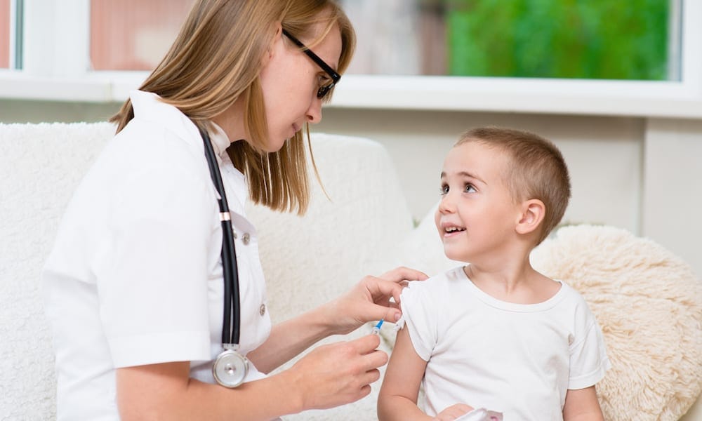 Immunisations Clinics happy little boy receiving injection or vaccine