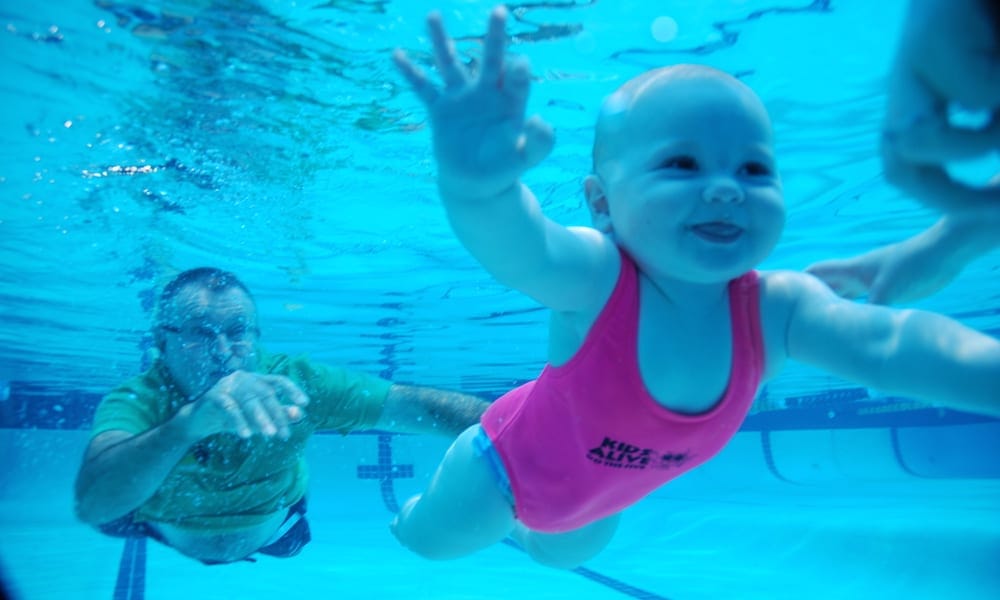 Laurie Lawrence and child in pool