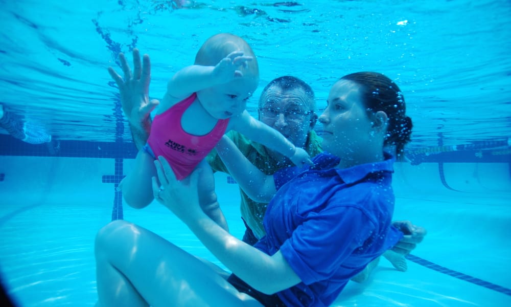 Emma Lawrence, Laurie Lawrence and child in pool