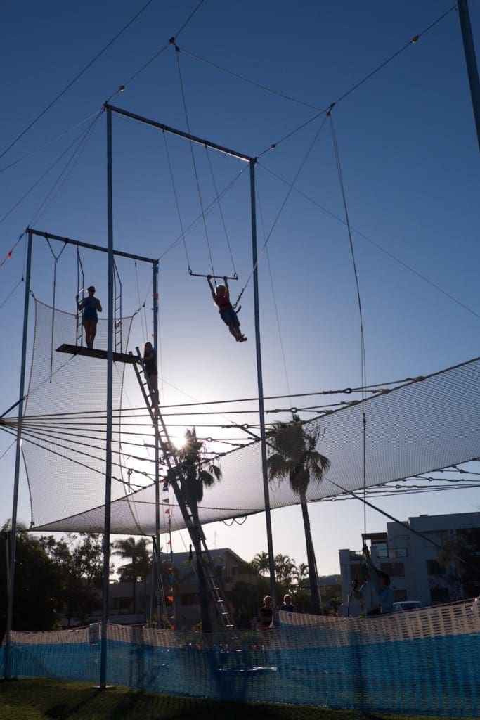 Circus Arts Trapeze dusk image of children learning trapeze outside