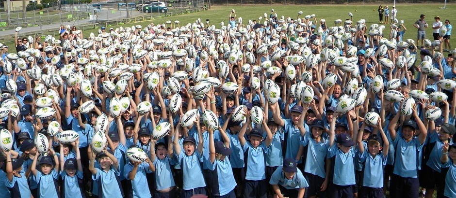 Marymount Catholic Primary School many students in uniform holding balls above their heads
