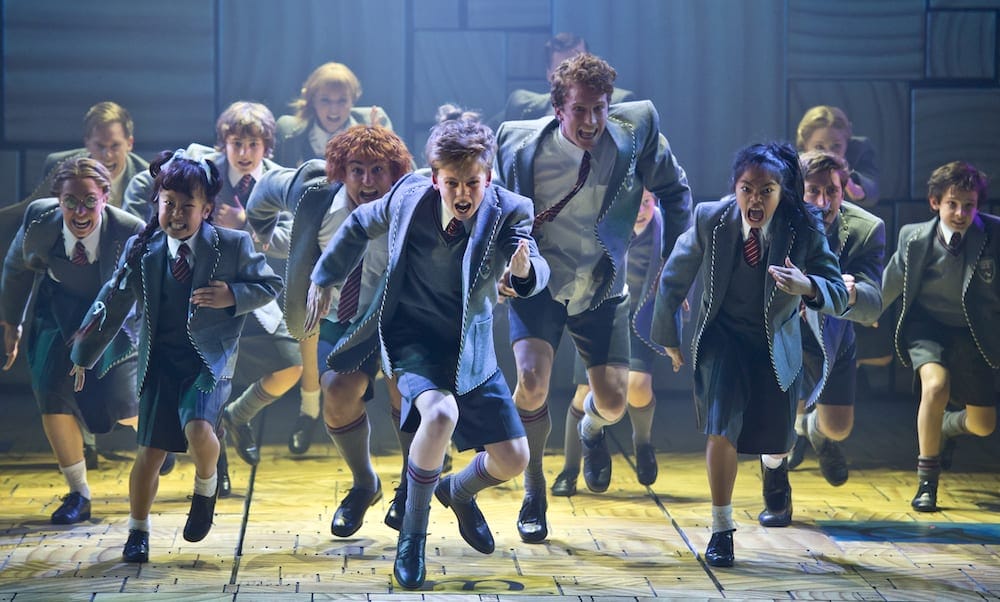Cast of Matilda The Musical performing on stage
