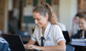 Tweed Valley Adventist College teenage girl sitting at desk in class while studying
