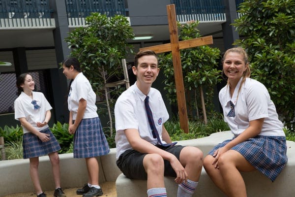 Aquinas College Parent Fact Sheet students in uniform sitting outside school smiling