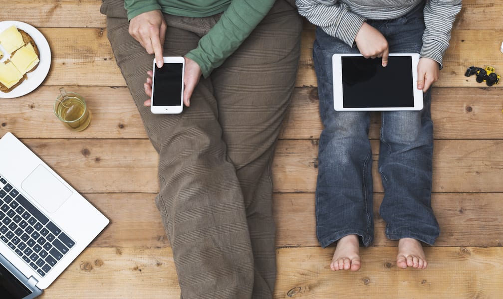 best podcasts and apps Mother and son using tablet and laptop