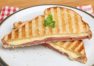 healthy breakfasts Toasted sandwich with beef pastrami and melting cheese.