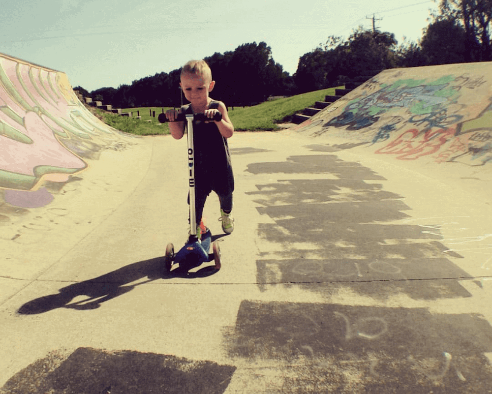 young boy riding scooter at cabarita skate park