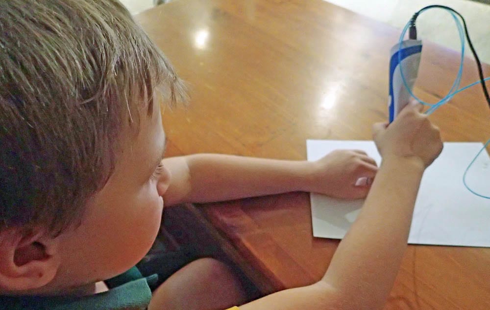 Child using a 3D pen