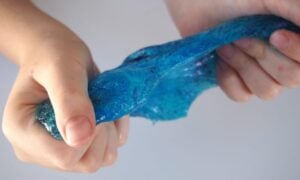 Hands stretching Glitter Slime