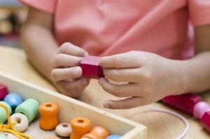 montessori school playing with beads