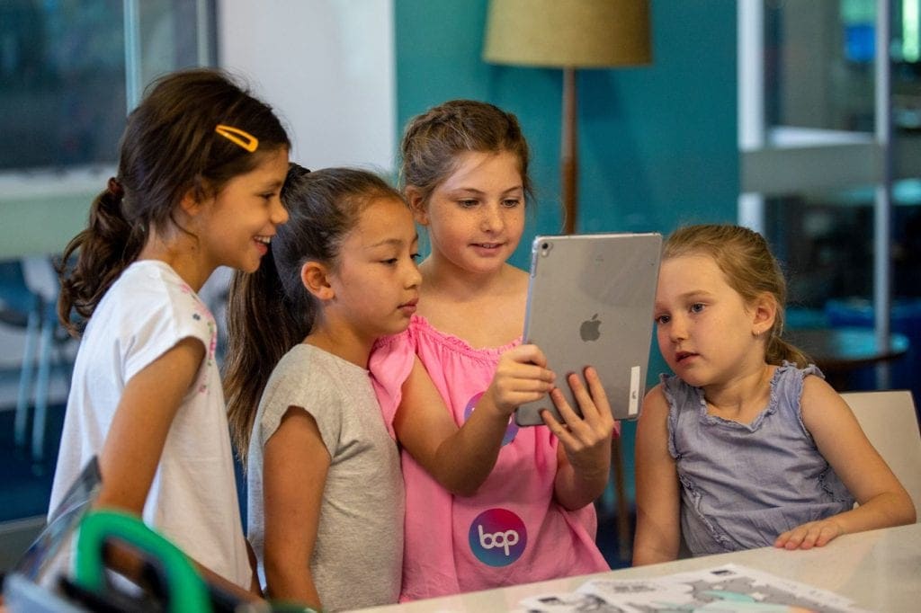 qut school holiday activities girls with ipad