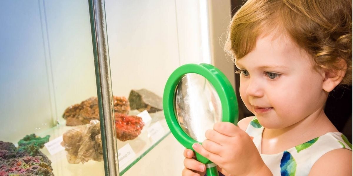 Toddler at QLD Museum with magnifying glass