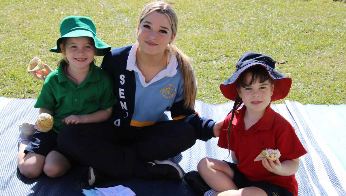 A senior student with some younger pupils at Faith Lutheran College