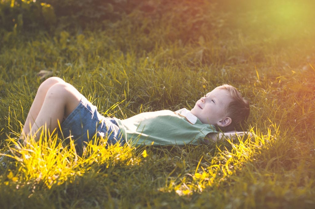 Child relaxing in grass