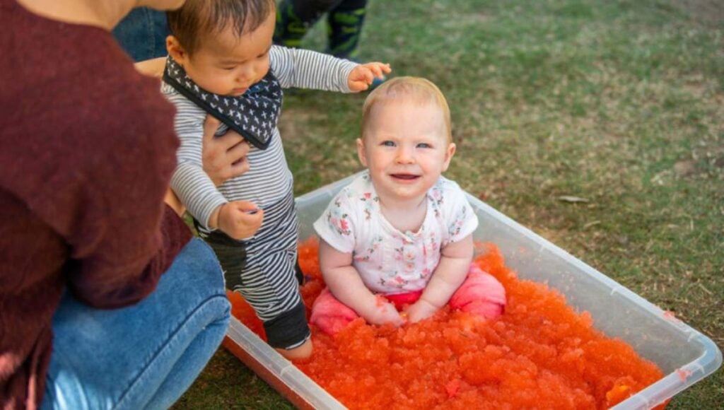 A toddler enjoying messy play