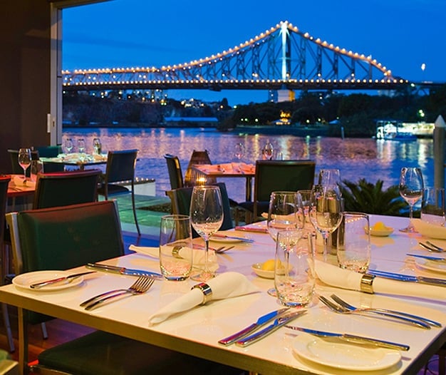 Dining table at Alchemy Restaurant, with view of the Story Bridge in the background. 