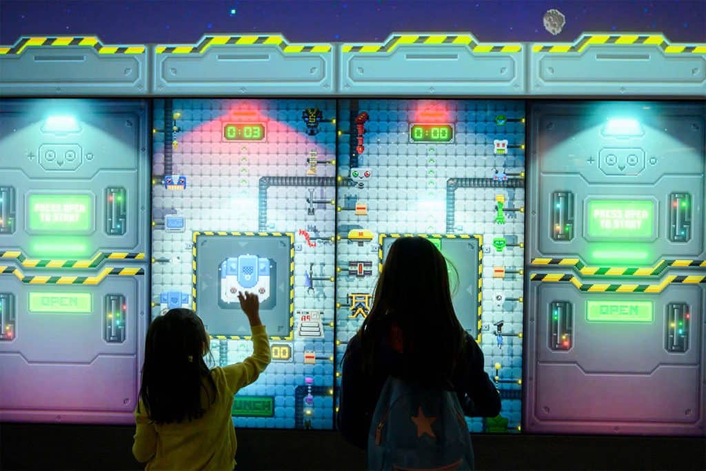 Children interacting with a digital screen to make their own robot