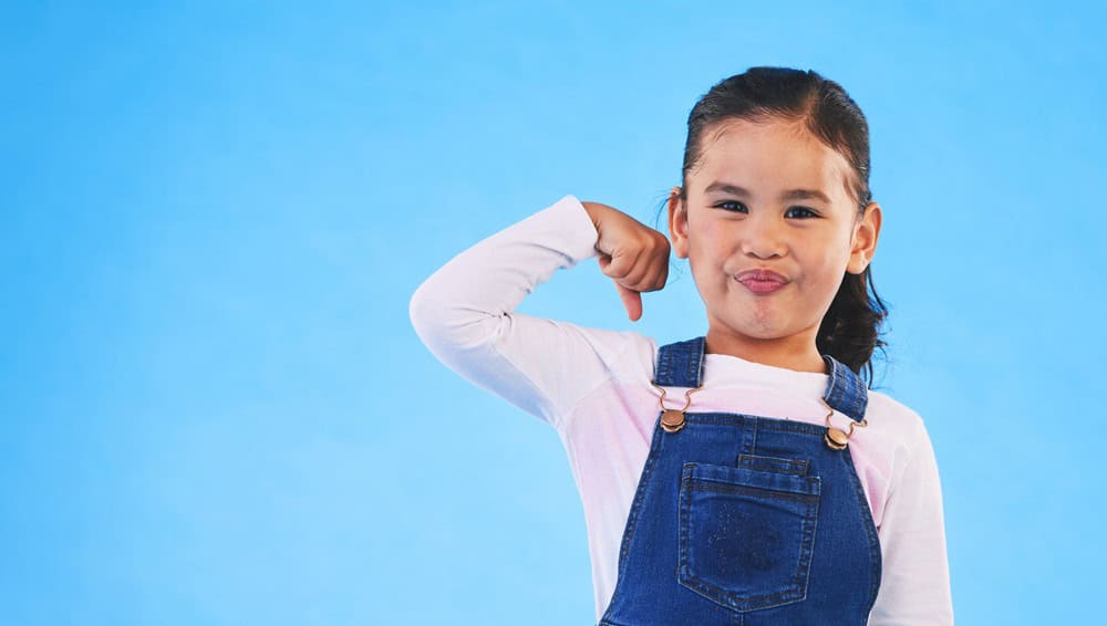 Little girl being strong and happy
