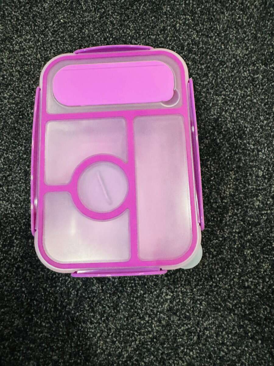 Closed purple kids’ bento lunch box with leak-proof lid and built-in utensil slot.