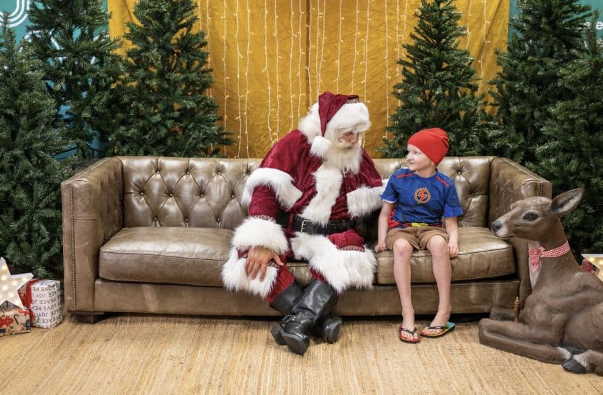 Young Brisbane boy sharing a joyful Christmas moment with Santa during a hospital visit at Queensland Children’s Hospital.
