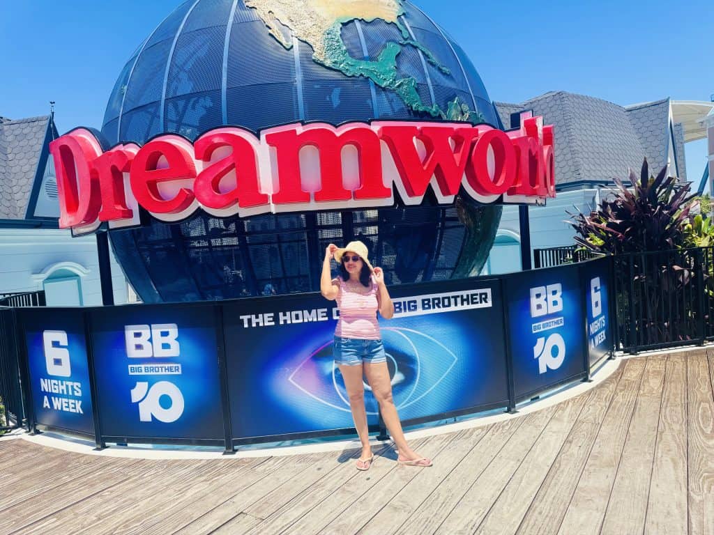 Family visit photo at the Dreamworld entrance on the Gold Coast, standing in front of the iconic Dreamworld globe.