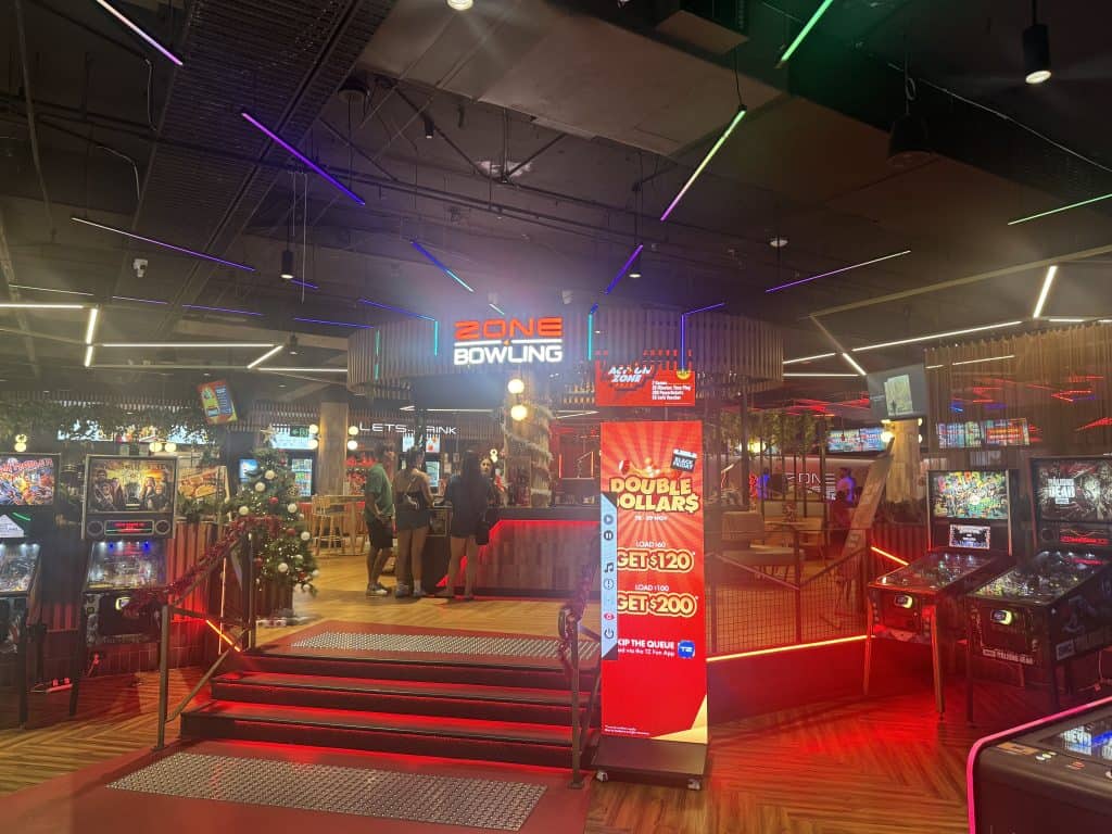 Inside the vibrant gaming and bowling arcade in Surfers Paradise, featuring arcade machines, neon lights, and family entertainment areas.