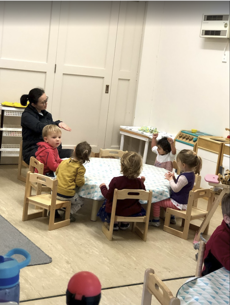 Children and educator during a group activity at an early learning centre in Australia.