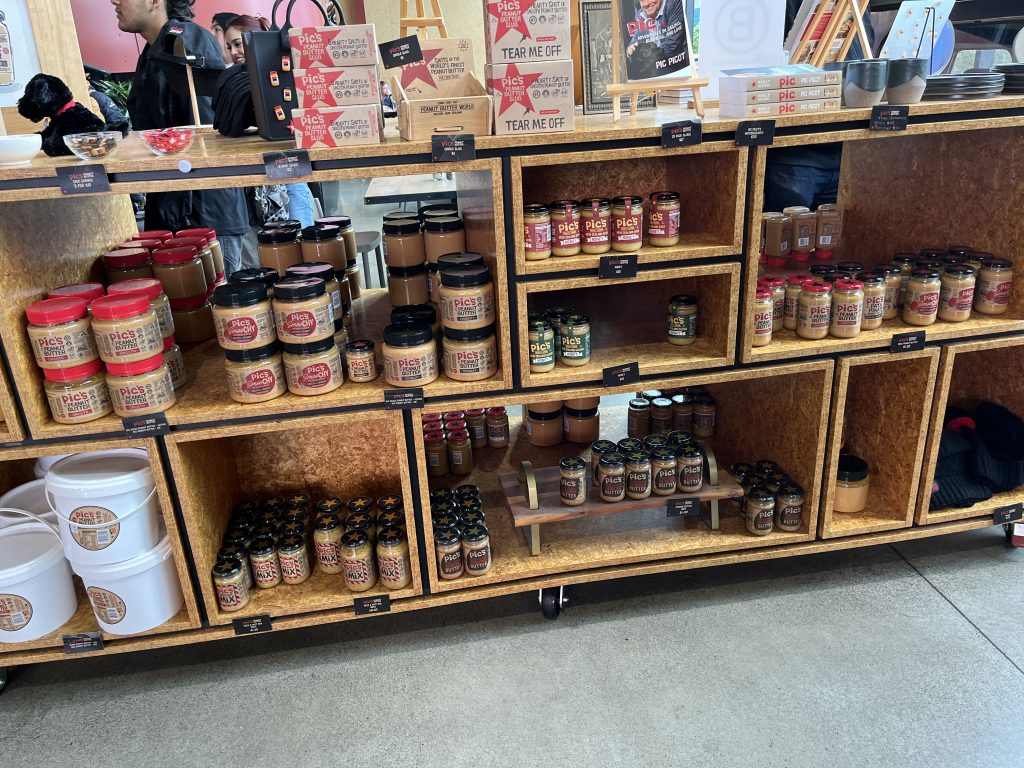 Shelves filled with Pic’s Peanut Butter jars and products inside the Pic’s Peanut Butter Factory shop in Nelson, New Zealand.