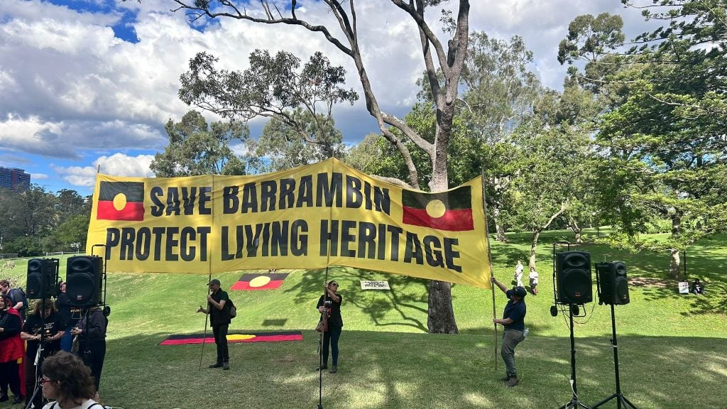 A Save Barrambin Protect Living Heritage banner displayed during a protest at Victoria Park in Brisbane.